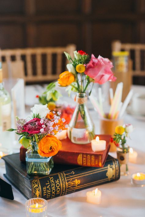 Short #reception #centerpiece with books as flower vase stand - babb photo Book Wedding Centerpieces, Historic Library, Unique Wedding Centerpieces, Book Centerpieces, Jenny Smith, Colorful Centerpieces, Book Themed Wedding, Literary Wedding, Flowers In Vases