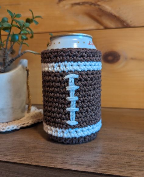 Crocheted football design koozie/can cooler for enjoying your favorite game day beverage! There may be slight variation from the photo (primarily with the laces) due to handmade nature of item.  Size: Fits 12oz aluminum can beverages Material: 100% cotton yarn Recommend spot cleaning or hand washing as the embroidered white laces may be damaged in washing machine. Football Koozie Ideas, Western Crochet Projects, Crochet Soda Can Cozy Patterns, Beer Coozie Crochet, Beer Cozy Crochet Pattern, Crochet Coozies Beer, Crochet Gifts For Gamers, Can Cozy Crochet Pattern Free, Crochet Beer Coozie