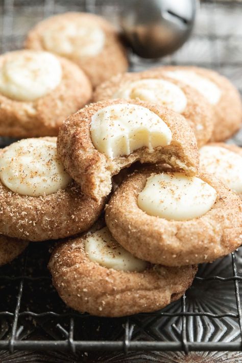 A soft cookie filled with eggnog ganache (with rum!) these Eggnog Snickerdoodle Thumbprint Cookies are a true taste of Christmas! #eggnogcookies #eggnogthumbprintcookies #eggnogsnickerdoodles Snickerdoodle Cookies Sallys Baking, Snickerdoodle Gingerbread Cookies, Iced Snickerdoodle Cookies, Egg Nog Snickerdoodles, Eggnog Snowball Cookies, Holiday Snickerdoodle Cookies, Soft Glazed Gingerbread Cookies, Eggnog Snickerdoodles Recipe, Ganache Thumbprint Cookies