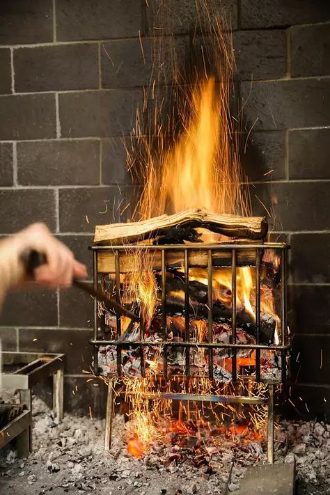 Sean O'Hara moves logs in the wood burning oven area at The French Laundry restaurant in Yountville, California, on Thursday, Feb. 16, 2017. French Laundry Restaurant, Yountville California, Pit Cooking, Wood Fired Cooking, The French Laundry, Diy Grill, Wood Burning Oven, Indoor Outdoor Kitchen, Bbq Grill Design