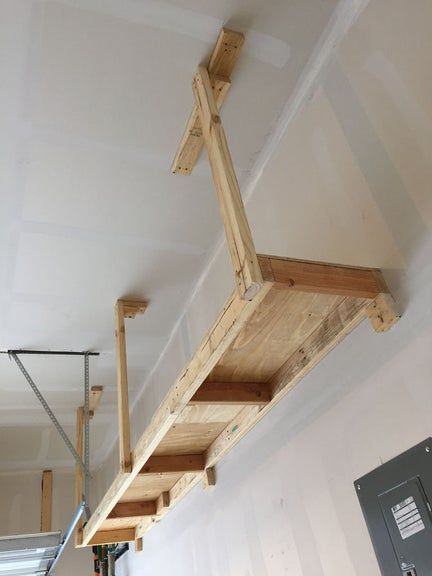 Above Garage Door Storage Diy, Above Garage Door Shelf, Garage Ceiling Shelves, Garage Overhead Storage, Diy Overhead Garage Storage, Garage Storage Units, Garage Storage Plans, Garage Ceiling Storage, Diy Garage Work Bench