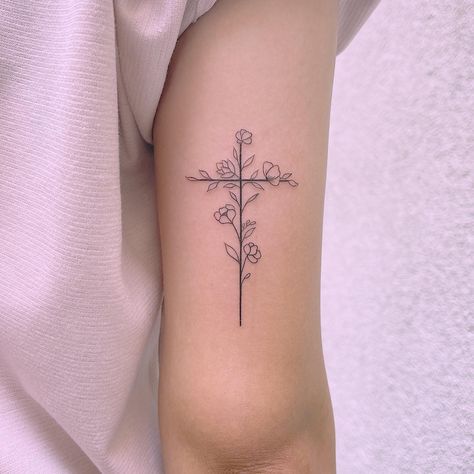 Tattoo For A New Beginning, Simple Cross Flower Tattoo, Cross On Tricep Tattoo, Simplistic Western Tattoos, Womens Cross Tattoo With Flowers, Flower Crosses Tattoo, Cross W Flowers Tattoo, Flower Cross Rib Tattoo, Crosses With Flowers Tattoo