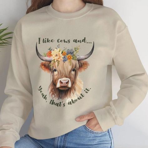 https://livandletdesign.etsy.com/listing/1798180846/cute-highland-cow-unisex-heavy-blend #highlandcowlove #highlandcow #highlandcattlesociety #scottishhighlandcattle #cowgirl #livandletdesign Cozy Wardrobe, Cute Highland Cow, Majestic Creatures, Floral Sweatshirt, Cow Design, Rodeo Shirts, Cow Shirt, Cowgirl Shirts, Boho Sweater