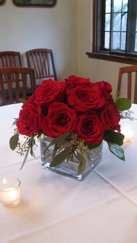 Simple and elegant red rose centerpiece Elegant Red Rose Centerpieces, Roses Centerpieces Quinceanera, Small Red Rose Centerpiece, Wedding Centerpieces Red Roses, Red And Green Centerpieces, Rose Centerpieces Simple, Rose Centerpieces Quinceanera, Red Flower Table Centerpieces, Red Rose Centerpieces Simple