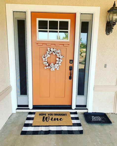 Farmhouse porch with burnt orange front door Burnt Orange Exterior Door, Front Door Colors Orange, Orange Trim House Exterior, White House Orange Door, Fun Door Colors Entrance, Tangerine Front Door, Orange Front Door White House, Copper Color Front Door, Dark Orange Front Door