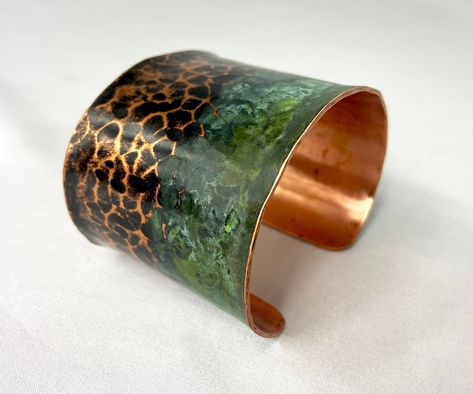 These unique, hand-formed copper and brass cuff bracelets with vibrant patinas create stunning accents to your personal style. Dress up or down- either way you'll be wearing an adornment that will turn heads, start conversations, and delight the eye of the beholder. This is a wide, hammered copper cuff with antique and green patinas. Colors look slightly different depending on the device you view the product on. This is a small size cuff, see measurements below. Cuffs have a 1” gap. Use a fabric Coloring Metal, Handmade Copper Bracelet, Patina Jewelry, Copper Bracelets, Brass Cuff Bracelet, Etched Copper, Metal Forming, Metal Smithing, Eye Of The Beholder