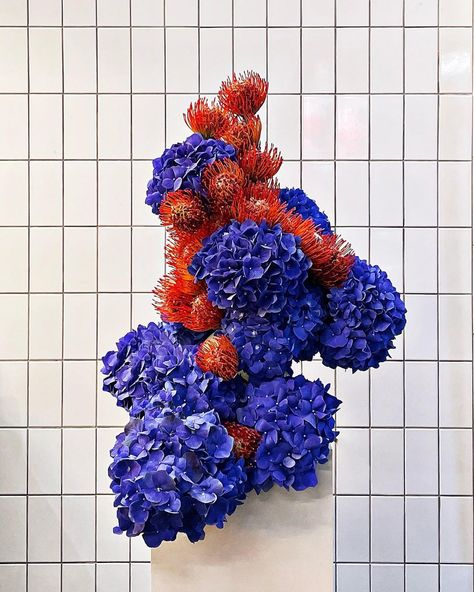 Credits @metatopy | Instagram Sculpture Flower Art, Blue Flowers Table Decoration, Flower Arrangements Design, Unusual Flower Arrangements, Hydrangea Floral Arrangements, Red Flower Arrangements, Luxury Flower Arrangement, Red And Blue Flowers, Flower Table Decorations