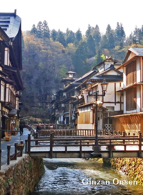 Ginzan Onsen (銀山温泉) is a hot spring village located in the mountains of Obanazawa of Yamagata Prefecture. The area is known as one of Japan’s prettiest onsen towns with their ryokans adjacent and parallel to the river. It is secluded in an area that developed around the silver mine.   #Japan #Travel #JapanTravel #JapanTours #TravelGuide #Tohoku Ginzan Onsen, Spring Village, Japan Village, Japanese Buildings, Japanese Town, Japanese Mountains, Japanese Village, Taisho Era, Villain Outfits