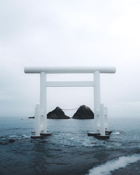 A white torii gate, entrance to a shrine at the shore of a beach Torii Gate, Fukuoka Japan, Aesthetic Japan, A Frog, Japan Photo, Abandoned Buildings, Fukuoka, Japan Travel, Insta Travel