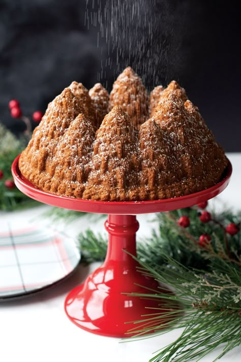 Baked vanilla chai spiced Bundt cake in Pine Forest Bundt design on a cake stand, dusted with powdered sugar Nordic Ware Recipes, Spiced Bundt Cake, Bundt Cake Decorations, Tin Cakes, Bundt Pan Recipes, Eggnog Cake, Cool Desserts, Bundt Recipes, Chai Spices