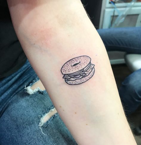 lox bagel tattoo done by James Eastwood at Insight Studios Chicago, IL Food Patchwork Tattoos, Everything Bagel Tattoo, Foodie Tattoos Ideas, Lunchbox Tattoo, Small Food Tattoos, Bagel Tattoo, Jewish Tattoo Ideas, Sandwich Tattoo, Foodie Tattoo