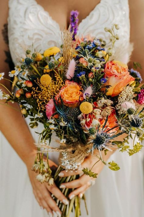 Discover stunning boho wedding florals to inspire your big day. From eclectic shapes to vibrant colors, these boho florals for wedding celebrations will bring a free-spirited atmosphere to your ceremony and reception. Explore our guide and find the perfect boho wedding flowers for your venue! Boho Wedding Colors Summer, Vintage Flowers Wedding, Vibrant Boho Wedding, Wedding Color Schemes Wildflower, Summer Flower Bouquet Wedding, Bright Fall Flowers, Vibrant Wedding Decor, Boho Floral Arrangements, Spring Wildflower Wedding