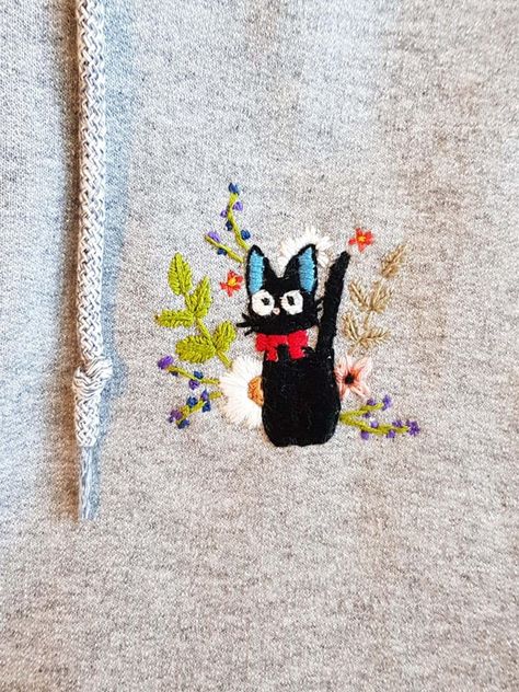 First shot at embroidering and made Jiji on a hoodie! S/O to u/moonrift for letting me sample her design :) : ghibli First Embroidery Project, Ghibli Embroidery Pattern, Jiji Embroidery, Ghibli Knitting, Hand Embroidery Hoodie, Embroidery Ghibli, Studio Ghibli Embroidery, Ghibli Embroidery, Embroidery On Hoodies