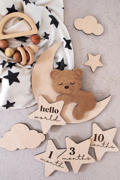 "✰ ALL options include ONE layered and engraved wood teddy bear, THREE small clouds, ONE small plain star (not engraved), ONE \"hello world\" engraved star and removeable putty to secure milestone marker/s ✰ Wood monthly milestones can be changed at any time ✰ Made from 1/4\" maple wood ✰ Laser cut  & engraved ✰ Sign is shown in raw maple ✰ The back is left unfinished on all pieces Disclosures: ✰ Please note that as wood is a natural material, each piece will have different graining, patterns and possible knots. No two items will ever be the same. Please keep small parts away from children. ✰ All products are made to order, signs can take 1 - 2 weeks, most orders are shipped within 1 week ✰ Props and clothing used in images not included Follow us on Instagram: @corinanielsen Follow us on T Acrylic Personalized Gifts, Laser Wood Projects, Wood Laser Cut Ideas, Laser Cut Gifts, Neutral Baby Decor, Laser Products, Cnc Machine Projects, Milestone Markers, Birth Stats Sign