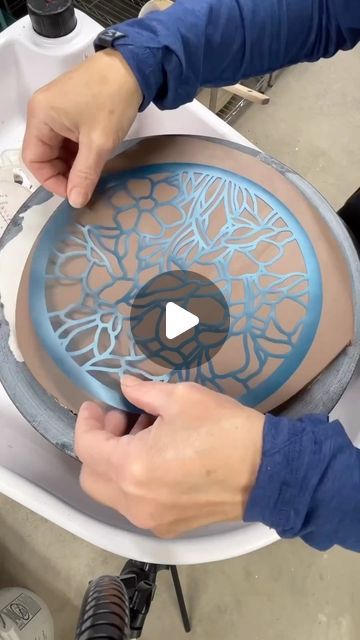 Christine Stangel on Instagram: "There she goes again! Something old mixed with something new!  Taking my traditional painted floral pottery line to a new level with the magic of technology. All summer and fall I have been learning the ins and outs of Photoshop along with my new Cricut Maker to create my own stencil designs. This gives me the ability to have more intricate details when painting flowers. Such a huge learning curve, but oh the possibilities! These trivets will be available this December! @wintercraftmarket #csstangelpottery" Pottery Tiles Ideas Design, Pottery Painting Ideas Guys, China Painting Ideas, Pottery Display Ideas Home, Wedding Pottery Ideas, Scraphito Ceramic, How To Paint Pottery, Stencil Ceramics, Stencil Pottery