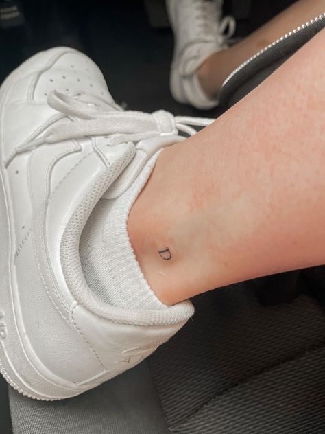 Ankle Tattoo Initials, Letter Ankle Tattoo, Sister Micro Tattoos, Mini Tattoos Ankle, Micro Sister Tattoos, Inside Of Ankle Tattoo, Ankle Tattoo Aesthetic, Ankle Number Tattoo, Number Tattoo Ankle