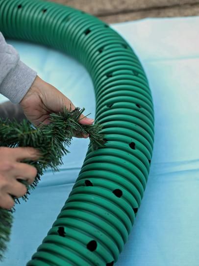 How to Make an Oversized Christmas Wreath | HGTV Decoracion Navidad Diy, Christmas Wreath Designs, Outdoor Christmas Wreaths, Large Christmas Wreath, Hgtv Shows, Drainage Pipe, Front Porch Christmas Decor Ideas, Porch Christmas Decor Ideas, Christmas Decor Ideas Diy