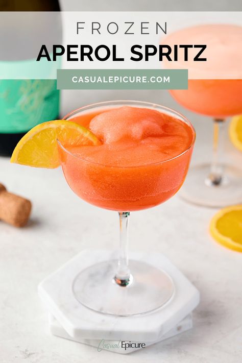 Cool off this summer with our easy Frozen Aperol Spritz, a frosty twist on the classic Italian cocktail. This refreshing drink blends Aperol ice cubes with Prosecco for a slushy texture that won't water down as you enjoy it. Perfect for poolside parties or lazy afternoon get-togethers. Frozen Aperol Spritz Recipe, Frozen Aperol Spritz, Boozy Treats, Frozen Pina Colada, Aperol Spritz Recipe, Strawberry Simple Syrup, Frozen Cocktail, Frozen Cocktail Recipes, Spritz Recipe