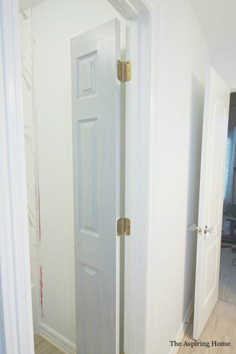 Easily solve a bathroom door issue by creating DIY petite double doors from bifold doors with this quick tutorial! Sometimes, when revamping a space, it takes more than paint and tile choice. It takes creative problem solving. I have found this to be true whether I am dealing with old or new construction. Case in point, this project. Read more on how the DIY petite double doors from bifold doors tutorial solved my issue and created much needed character.   When I sat down to pull… Sliding Double Doors Interior Small Spaces, Bifold Accordion Doors, Paint Bifold Doors, Bathroom Closet Door Ideas Small Spaces, Bifold Door For Bathroom, Vertical Split Door, Tiny Bathroom Door Ideas, Diy Bathroom Door Ideas, Bifold Door Bathroom