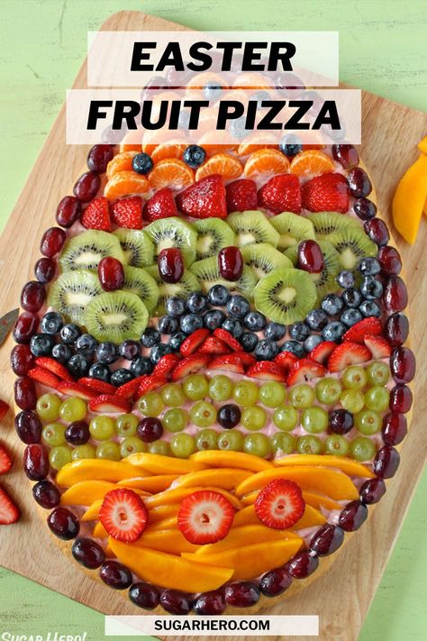 This Easter Fruit Pizza is the perfect Easter recipe! Serve this beautiful fruit pizza for breakfast, brunch, or even as a light Easter dessert. It has an Easter Egg sugar cookie crust, a generous layer of strawberry frosting, and lots of fresh fruit. #sugarhero #easterdessert #fruitpizza #easterfruitpizza Egg Fruit Pizza, Sugar Cookie Easter, Easter Egg Fruit Pizza, Easter Tart, Egg Fruit, Fruit Pizza Sugar Cookie Recipe, Fruit Sugar Cookies, Easy Easter Recipes, Easy Fruit Pizza