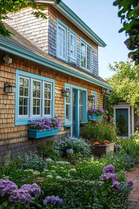 Charming coastal cottage with light blue siding, white trim, and a welcoming front porch. Cute Beach House Exterior, Cottage Exterior Makeover, Light Blue Siding, Blue Siding White Trim, Contemporary Beach House Exterior, Modern Coastal Home Exterior, Coastal Exterior House Colors, Coastal Beach House Exterior, Coastal Cottage Exterior