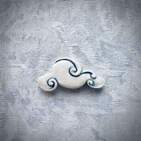 "This ceramic cloud tile is great for mosaic artwork and craft projects like mixed media. Think garden art with a sky included!  This hand painted tile is from Barb's Cottage, famous for unique mosaic supply.  This listing is for 1 ceramic molded tile: a blue & white cloud.  Size     * 1-1/4\" tall     *  2-1/4\" across     * 3/8\" thick Photos Photos include a video of the tile as well as several close-ups, & one of the tile back. As you can see, our tiles are flat and unglazed on the back, making them perfect for a mosaic project.  Inspiration In the past, clouds were notoriously difficult for mosaic artists, but no more! This beautiful cloud will enhance your next mosaic that includes sky. Photos include an inspiration piece that includes a sky with clouds that were made the old-fashion Ceramic Clouds, Cloud Clay, Wall Shrine, Cloud Ceramic, Wall Shrines, Whimsical Pottery, Sky With Clouds, Painted Tile, Hand Painted Tile