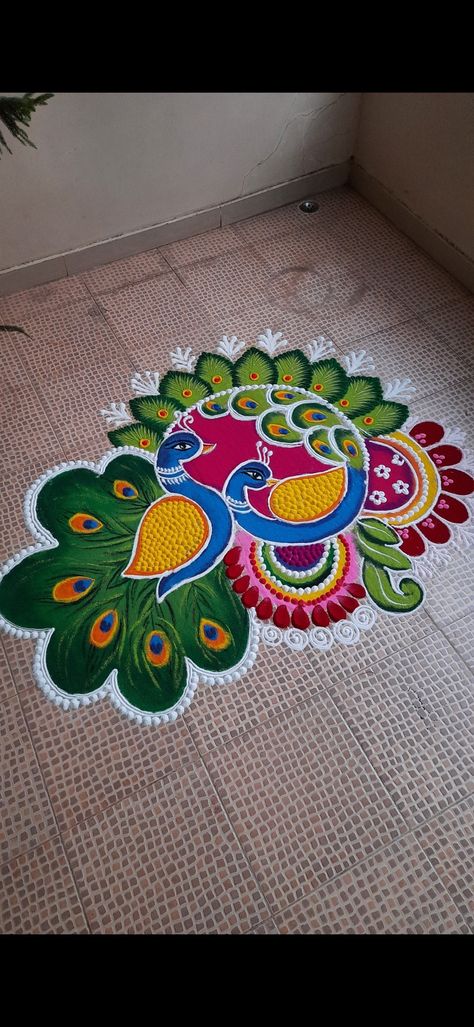 Ragoli Color Design Peacock, Simple Varamahalakshmi Background Decoration Ideas, Unique Rangoli Designs Beautiful Peacock, Rangoli Designs For Diwali Peacock, Trending Rangoli Design For Diwali, Flower And Rangoli Design, Big Border Rangoli Designs, Rangoli From Paint, Peacock Rangoli With Flowers