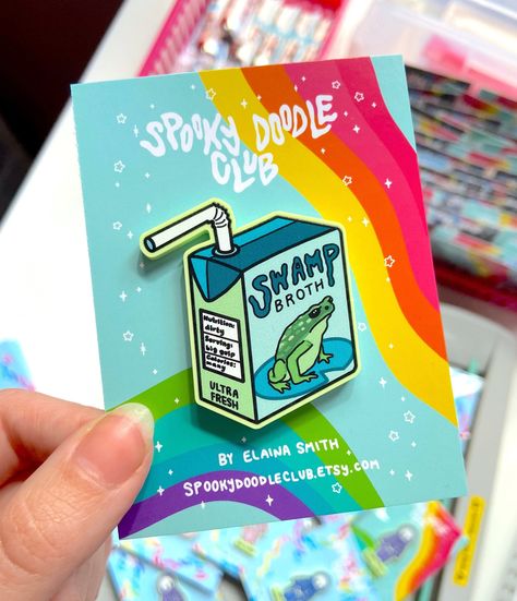 Spooky Doodle Club acrylic pin featuring a swamp broth juicebox. Perfect for fans of spooky and cute things! #spookydoodleclub #spooky #cute #pin . #Juice_Box_Art #Winona_Mn #Cosplay_Wings #Frog_Gifts Enamel Pin Design, Winona Mn, Juice Box, Acrylic Pins, Pin Design, Cute Doodle Art, Mushroom Art, Poster Stickers, Cool Stickers