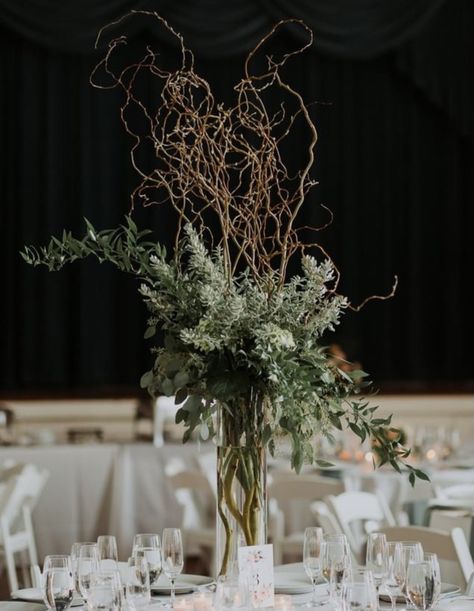 Vine Centerpieces, Tall Evergreen Centerpiece, Evergreen Table Centerpieces, Leafy Centerpieces, Enchanted Forest Flower Arrangement, Woodsy Floral Arrangements, Tall Branch Centerpiece, Forest Tablescape, Forest Quinceanera