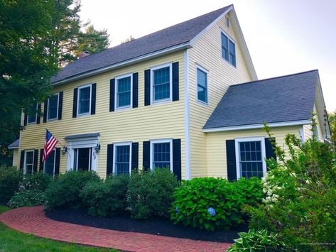 Yellow colonial house with black shutters and white trim Yellow House Black Shutters, Colonial Revival House Exterior, Colonial Home Exteriors, House With Front Porch, Colonial Shutters, Small Colonial, Door Accents, Colonial Revival House, Yellow Exterior