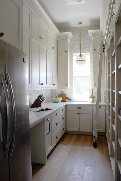 Well appointed walk-in pantry is equipped with a stainless steel refrigerator recessed beneath light gray cabinets painted in Benjamin Moore Edgecomb Gray and accented with Armac Martin Queslett Hardware. Benjamin Moore Edgecomb Gray, Pantry Layout, Beautiful Pantry, Modern Country Kitchens, House Pantry, Pantry Inspiration, Edgecomb Gray, Light Gray Cabinets, Pantry Laundry Room