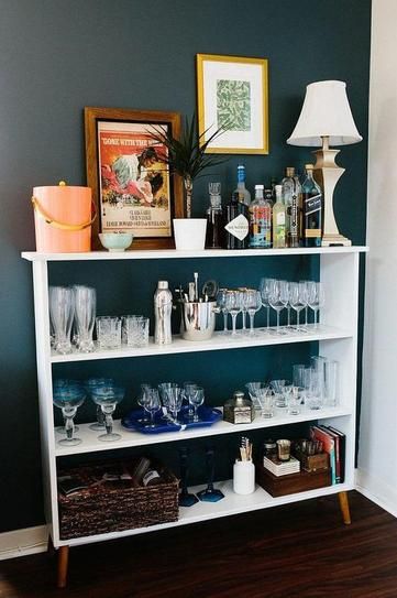 7 genius small kitchen ideas - use a bookshelf if you're lacking cabinet space Bookcase Into Bar, Bookshelf Into Bar, Bar Cart Bookshelf, Drinks Shelf Ideas, How To Decorate A Bar, Cocktail Shelf, Bar Bookcase, Bar Bookshelf, Small Bar Ideas