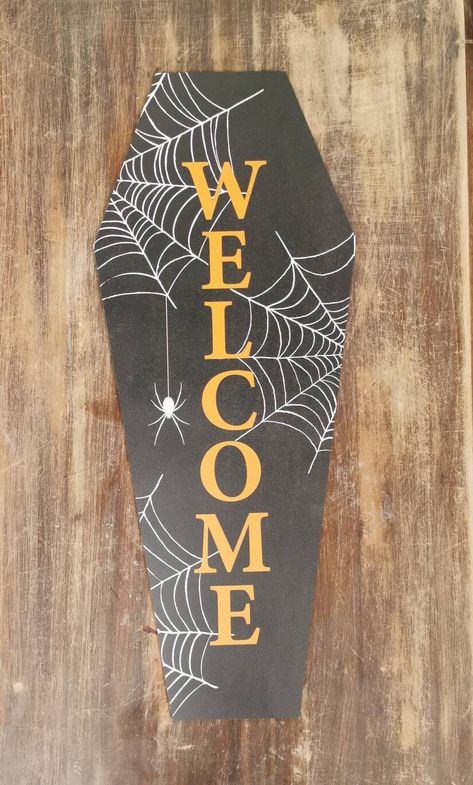 30.7cm wide by 75cm tall. This coffin shaped 'Welcome' sign is the perfect addition to your Halloween party decor. Add it to a balloon arch for a real statement entrance, or simply prop up in a window to show that you are welcoming Trick or treating this year. Adding some LED fairy lights behind it would really add to the spookiness. Printed in bold colours on a black ink , on 6mm MDF wood and cut to shape. Coffin Shaped Welcome Sign, Halloween Welcome Sign Front Door, Welcome Halloween Sign, Coffin Sign Halloween, Coffin Welcome Sign, Leaner Boards, Home Decor Glam, Wood Halloween Decorations, Halloween Welcome Sign