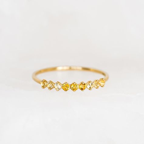 Inspired by the mystical allure of birthstones. This exquisite ring showcases 9 shimmering citrine gemstones, meticulously crafted in 14k gold. Perfect as a meaningful gift to yourself or a loved one born in November! Citrine (November birthstone) is the stone of positivity and optimism 3 deep citrine stones, each with a width of 1.75mm 6 light citrine, each with a width of 1.75mm 14k yellow gold band Ombre Rings, Gold Ombre, March Birthstone Ring, November Birthstone Ring, Blue Topaz Stone, Big Rings, March Birthstone, Detailed Ring, Citrine Stone