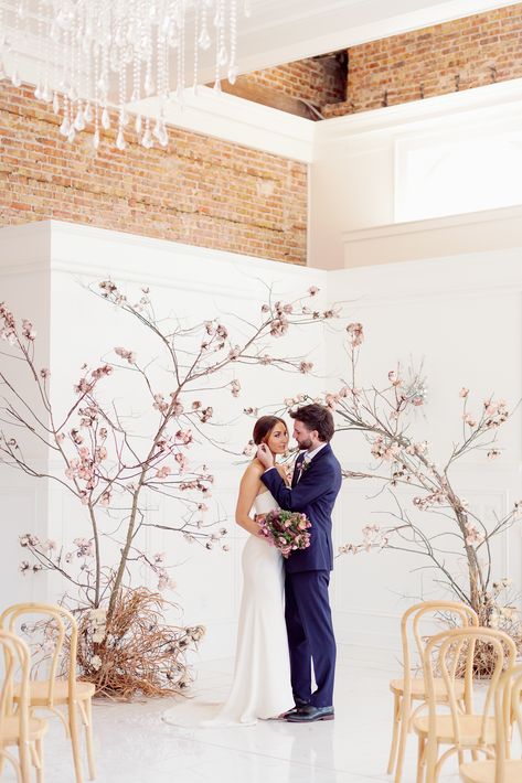 DREAMY MODERN CHERRY BLOSSOM-INSPIRED SPRING STYLED WEDDING SHOOT AT THE TREASURY via WedPlan Madison Spring Photoshoot Ideas Indoors, Spring Styled Shoot, Cherry Blossom Installation, Japandi Wedding, Cherry Blossom Backdrop, Cherry Blossom Arch, Japanese Style Wedding, Cherry Blossom Wedding Decor, Branches Wedding Decor