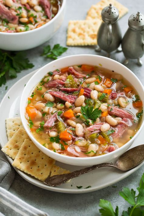 Ham and Bean Soup - a homestyle, hearty and delicious soup that couldn't be easier to make! It requires minimal ingredients including a leftover ham bone, dry beans, some veggies, herbs and broth and the slow cooker does just about all of the work. #ham #bean #soup #dinner #slowcooker #crockpot #easydinner #dinnerideas #fromscratch #homemade #crockpotsoup Ham Bone Recipes, Greens Soup, Ham Soup Recipes, Ham And Bean, Slow Cooker Ham, Crockpot Ham, Bean Soup Recipe, Soup Beans, Ham Bone