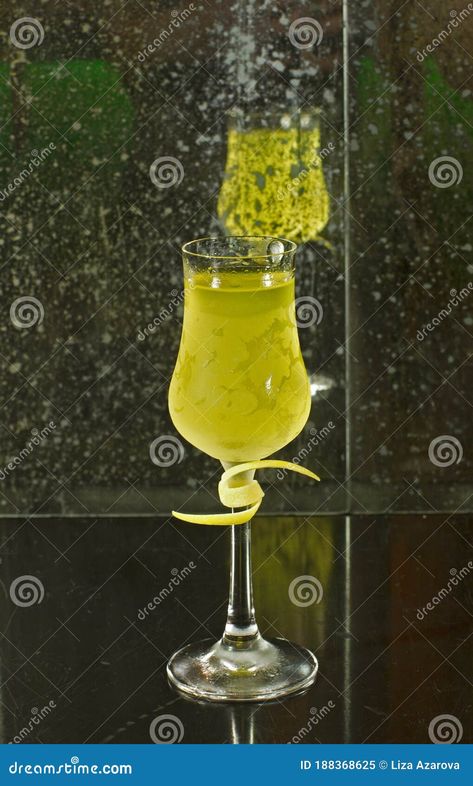 Vertical close up drink shot of a delicious fresh yellow limoncello lemon liqueur cocktail in a transparent glass standing on a table, reflected in a dirty mirror in the background Limoncello Drinks, Classic Background, Easter Portraits, Limoncello Cocktails, Dirty Mirror, Chocolate Truffles, Liqueur, Dining Table Setting, Brighten Your Day