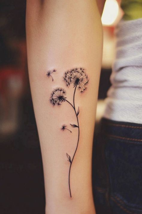 Dandelion tattoo on an arm with seeds blowing away. Dandelion Rib Tattoo, New Beginning Tattoos, Dandelions Tattoos, Wish Flower Tattoo, Wind Tattoos, Blowing Dandelion Tattoo, Dandelion Tattoo Ideas, Dandelion Tattoo Meaning, Dandelion Tattoos