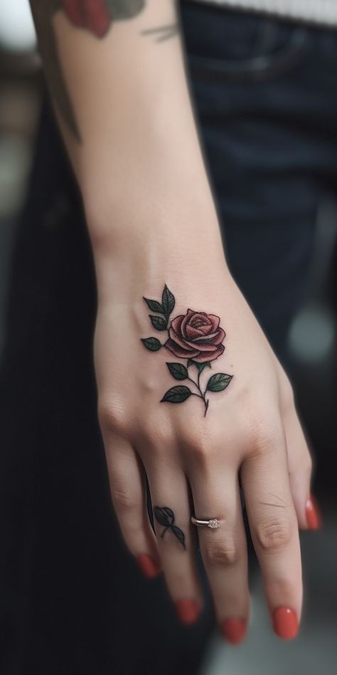 A lovely petite rose hand tattoo, featuring detailed shading and fine lines, exuding grace and elegance. This delicate design embodies love, passion, and beauty, making it an ideal choice for those seeking a meaningful and artistic representation of their individuality and emotions on their hand. Small Red Rose Tattoo, Rose Hand Tattoos, Bud Tattoo, Rose Bud Tattoo, Rose Chest Tattoo, Cover Up Tattoos For Women, Simple Rose Tattoo, Thumb Tattoos, Rose Hand Tattoo