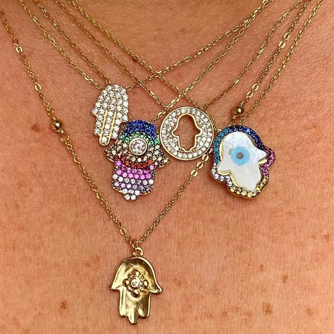 Looking for a fresh spin on the enduring, time-honored hamsa? When you take traditional symbols and imbue them with modern style, what you get is the Colorful Halo Hamsa Necklace! A sky-blue evil eye fills the hamsa's form, keeping all your guiding and guarding bases covered, and the whole pendant is trimmed in a frame of vivid crystals. Made for the wearer whose clear vision sees the extraordinary potential disguised within ordinary things. 14k gold plated sterling silver Pearlized evil eye pen Hamsa Necklace Silver, Evil Eye Fashion, Open Palm, Uncut Gems, Hamsa Necklace Gold, Spiritual Eyes, Nose Ring Jewelry, Evil Eye Art, Hamsa Jewelry