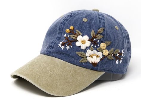 This hand embroidered flower baseball cap is a one-of-a-kind accessory that combines style and comfort. The cap is crafted from high-quality material, ensuring durability and comfort. The intricate floral design is hand-embroidered, giving each cap a unique touch and making it a standout piece. Whether you're running errands or enjoying a day outdoors, this cap will keep the sun out of your eyes in style. Flower is 100% hand embroidered on a 100% cotton baseball cap. Hat is one size fits all wit Embroidered Hats Baseball Caps, Bone Bordado, Pretty Hats, Embroidery Caps, Embroidery Stitches Tutorial, Embroidery Bags, Hat Embroidery, Embroidered Hat, Embroidery On Clothes