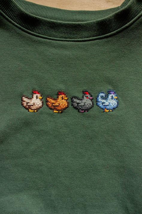 Cross Stitch Shirt Design, Cross Stitching On Clothes, Cross Stitch On Tshirt, Cross Stitch T Shirt, Stardew Valley Sweater, Stardew Valley Knitting, Pixel Art Embroidery, Silly Cross Stitch, Cross Stitch Sweatshirt