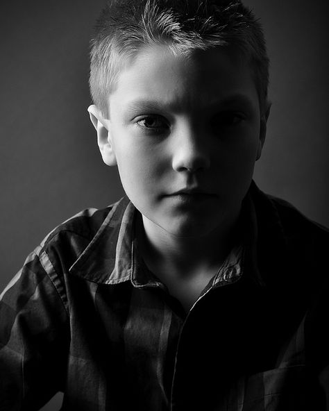 Portrait photo of a boy taken using split lighting with very little fill, so the shadow side of the subject's face appears very dark Exam Moodboard, Lowkey Portrait, Split Photography, Photography Inspiration Quotes, Rembrandt Lighting, Photography Lighting Techniques, Split Lighting, Photography Lighting Setup, Photography Board