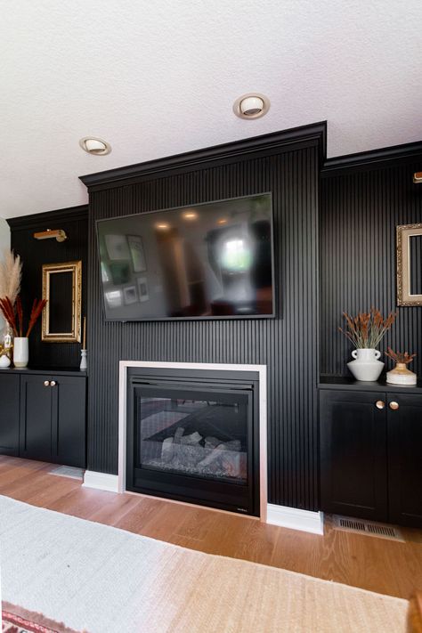 Black Accent Wall With Fireplace And Tv, Wood Slat Fireplace Wall With Mantle, Black Fluted Fireplace, Mantle Black Fireplace, Wood Panel Fireplace Wall, Black Living Room Walls, Wood Panel Fireplace, Black Modern Fireplace, Dark Fireplace Wall