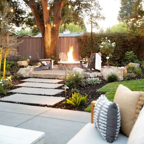 Check out our client's cozy backyard space with an outdoor fireplace and some patio string lights.Patio light string ideas | String lights outdoor | Outdoor string lighting ideas | Deck lighting ideas Fire Pit Ideas Backyard With Pavers, Elevated Outdoor Sitting Area, Paverstone Patio Ideas, Pool House Lighting, Pnw Backyard Ideas, Seating Area Under Tree, Patio Plants Ideas, Backyard String Lights Ideas, Colonial Backyard