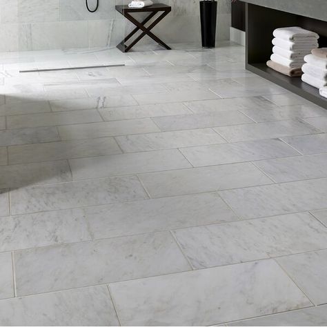 Install Carrara 12" x 24" Natural Stone Field Tile in Gray to incorporate a distinctive, contemporary aesthetic enhancement into kitchens, bathrooms and more. This tile combines a brilliant Gray color with distinct streaks of gray in a smooth finish to create a great complement to your decor. This tile is great for a wide variety of commercial and residential projects. With a large selection of sizes and accessories to choose from, this tile can easily be laid in a pattern or single layout and Honed Marble Floor, Cement Tile Floor, Marble Herringbone, Marble Subway Tiles, Emser Tile, Honed Marble, Accent Tile, Marble Tile, Marble Floor