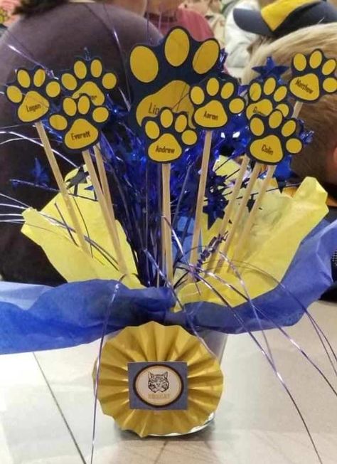 Looking for fun ideas for your Cub Scout Blue and Gold Banquet decorations? You'll find lots of decor suggestions including table centerpieces. #CubScouts #CubScout #Scouting #Webelos #ArrowOfLight #BlueAndGold #Banquet #BlueAndGoldBanquet #CubScoutIdeas Blue And Gold Banquet Centerpieces, Cub Scout Blue And Gold Banquet Ideas, Cub Scouts Blue And Gold Banquet Ideas, Blue And Gold Banquet Ideas Cub Scout, Blue Gold Centerpieces, Round Table Centerpiece Ideas, Blue And Gold Banquet Ideas, Cub Scout Blue And Gold Centerpieces, Blue And Gold Centerpieces