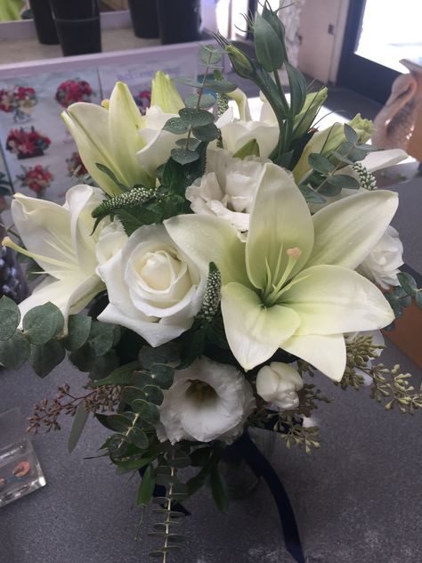 Handheld bouquet of white lilies  White roses, white Lisi, seeded eucalyptus and spiral eucalyptus Handheld Bouquet, Spiral Eucalyptus, Lilies White, Seeded Eucalyptus, Roses White, Lily White, White Lilies, Flower Market, Monterey