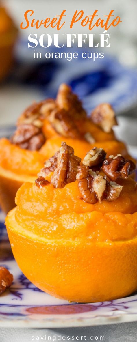 A light fluffy sweet potato filling flavored with fresh squeezed orange juice, topped with cinnamon sugar pecans and baked in an orange cup - a lovely side dish for your holiday buffet table! #orangesweetpotatoes #sweetpotatoes #sweetpotatosouffle #holidaysidedish #soufflé #potatoes #thanksgiving #christmas Sweet Potatoes In Orange Cups, Orange Sweet Potato Recipes, Sweet Potato Casserole Orange Juice, Sweet Potatoe Sufle Easy, Sweet Potato Orange Cups, Sweet Potato In Orange Cups, Orange Juice Sweet Potatoes, Sweet Potato Souffle Recipes Canned Yams, Sweet Potatoes With Orange Juice Recipe