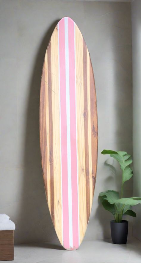 The Original Decosurf Bella Pink Surfboard Artwork Decor. Luxury hand-crafted wood surfboard decoration and artwork.Available in 2 through 6 foot sizes. Fully customizable upon request.This stunning surfboard features a timeless two-tone wood grain design, blending classic elegance with a touch of playfulness. The cheerful pink and white color scheme adds a vibrant twist, while the golden oak stained center stripe and natural wood stringers create a harmonious contrast. Deep, rich stained stripes elegantly frame the board, emphasizing its tropical allure. This exquisite decorative surfboard will be meticulously handcrafted with love, exclusively for you.The natural aspects of each board, including knots and woodgrain tone, will vary per individual product. I carefully analyze the woodgrain